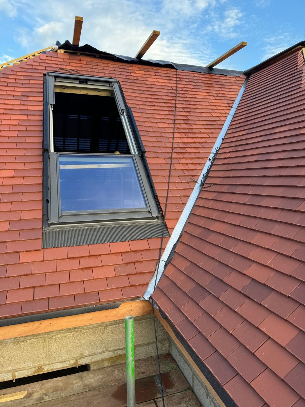 Plain clay tile roof with lead valley and roof window